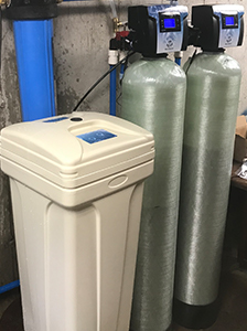 Twin tank water softener and brine tank installed by the Jones owners in a Missouri basement